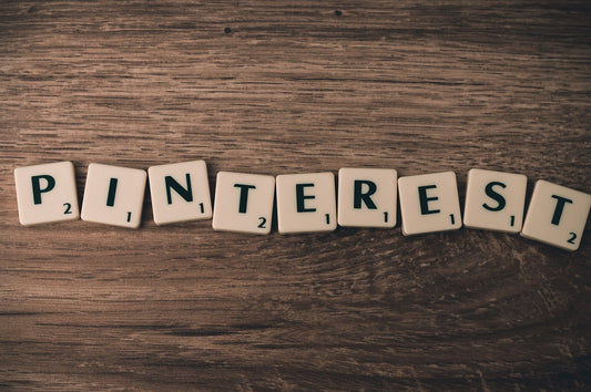 Holzplatte mit Scrabble-Buchstaben, die das Wort Pinterest bilden – Symbol für kreatives Arbeiten und Online-Marketing mit Pinterest.